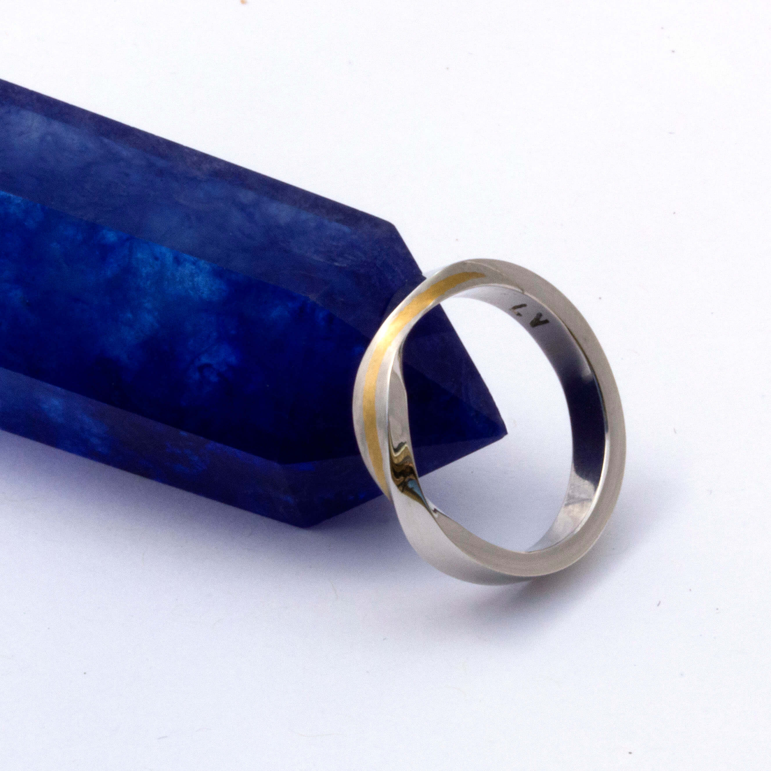 platinum and yellow gold inlay twist band with blue crystal