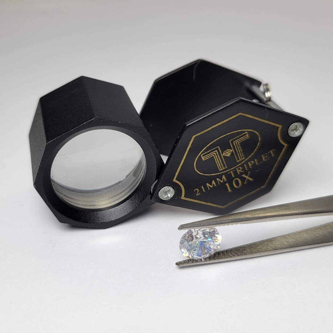 jewelry loupe with stone in tweezers