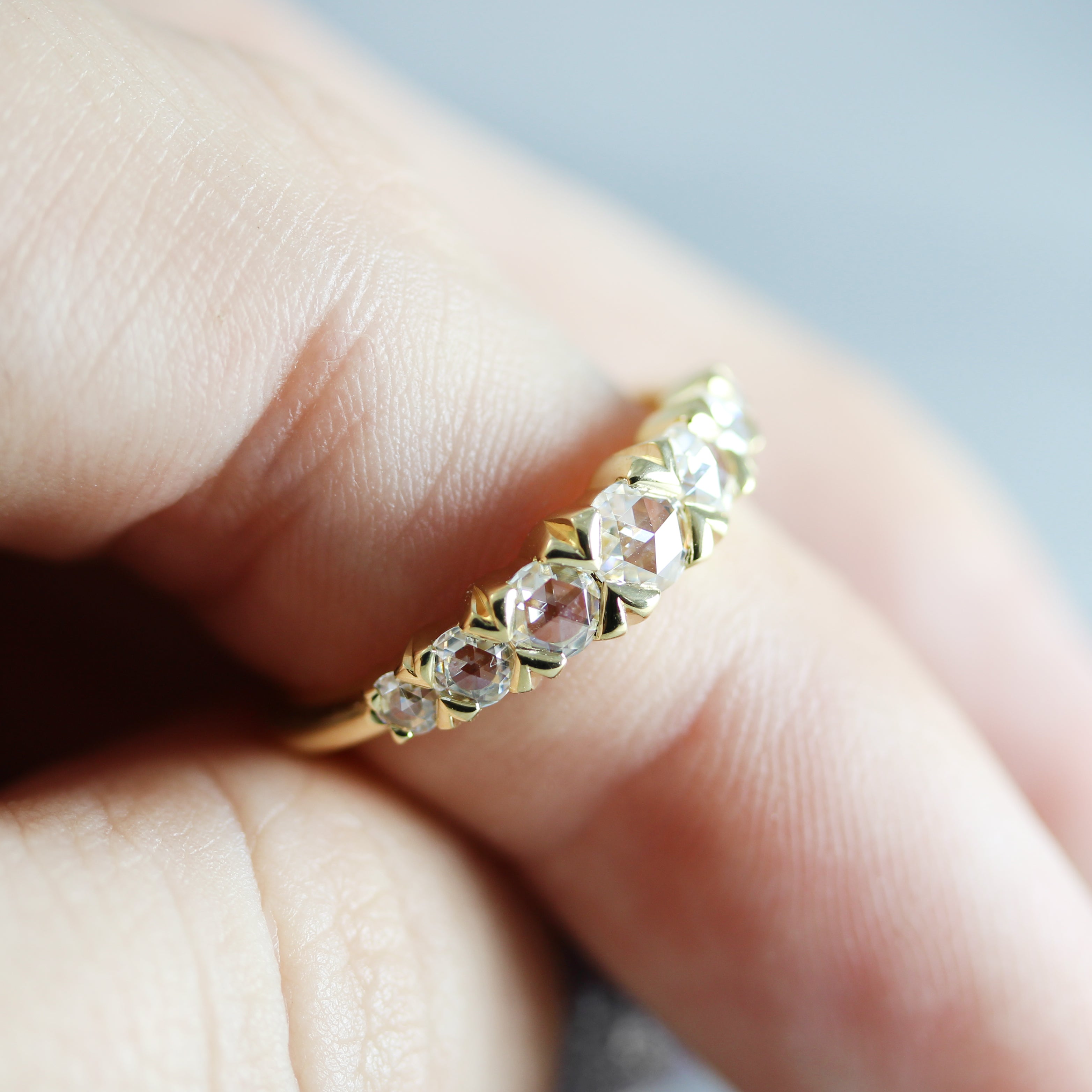 rose cut moissanite french cut yellow gold band on finger