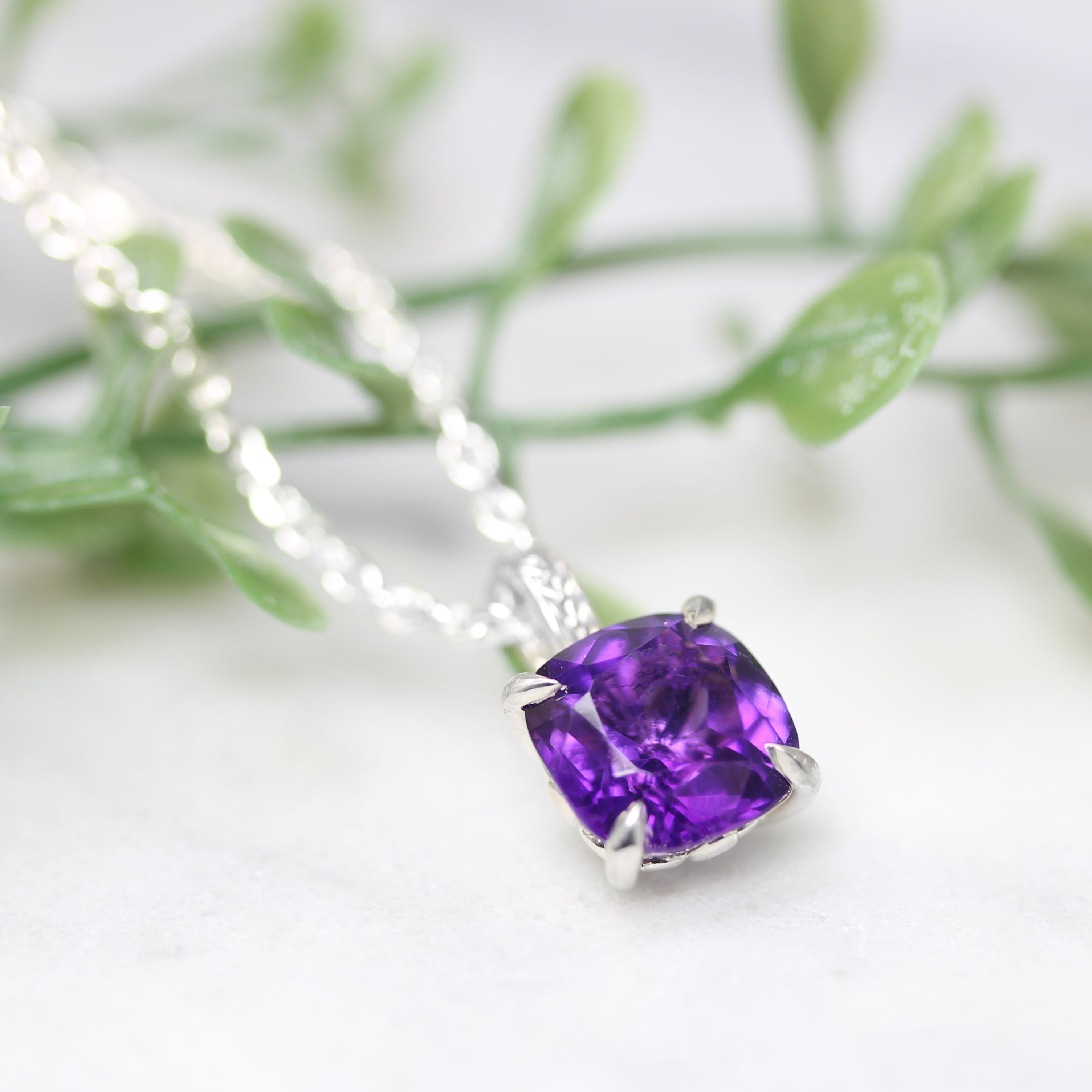 amethyst silver pendant angled view with greenery
