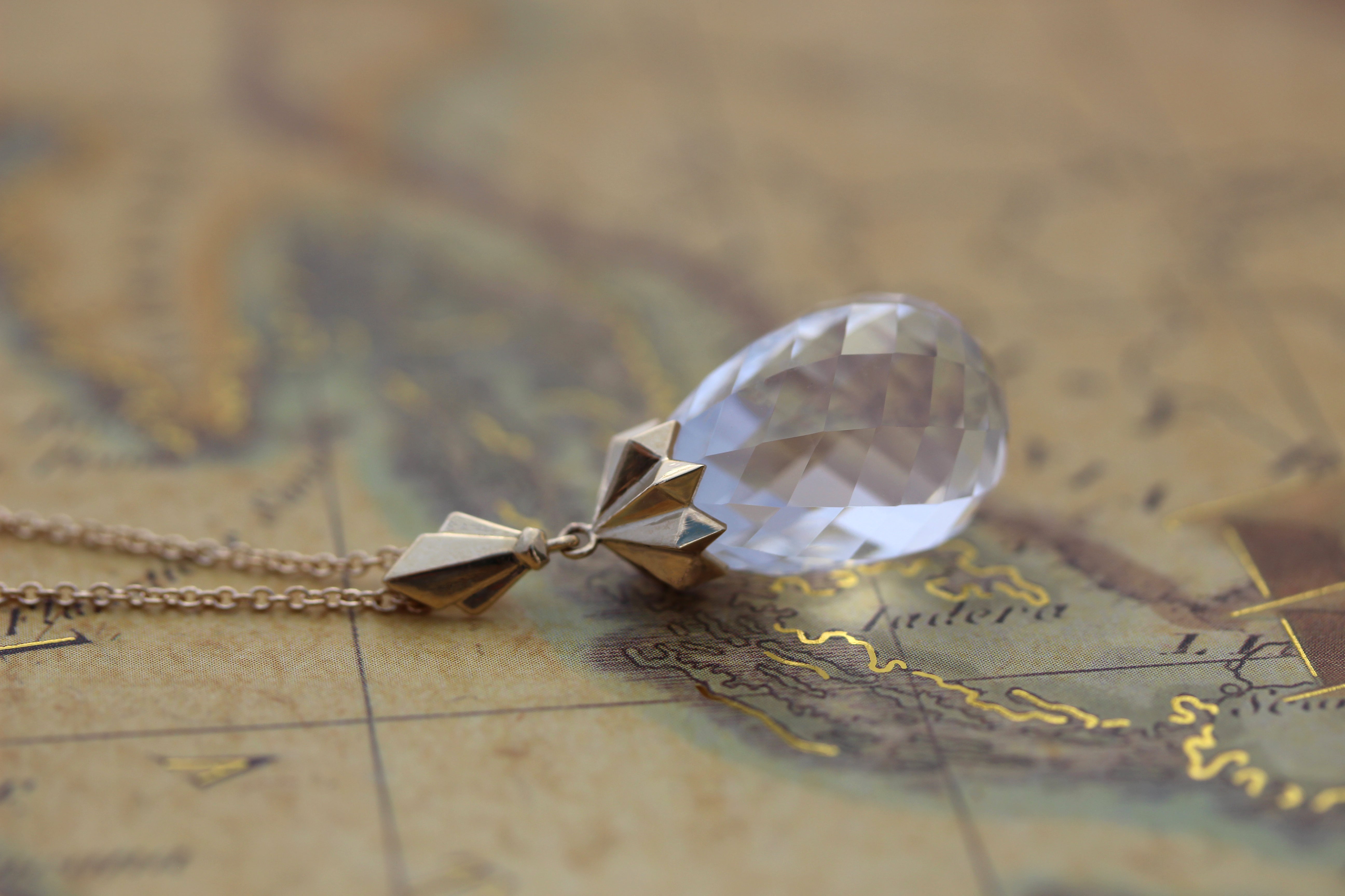 art deco briolette pendant on vintage map