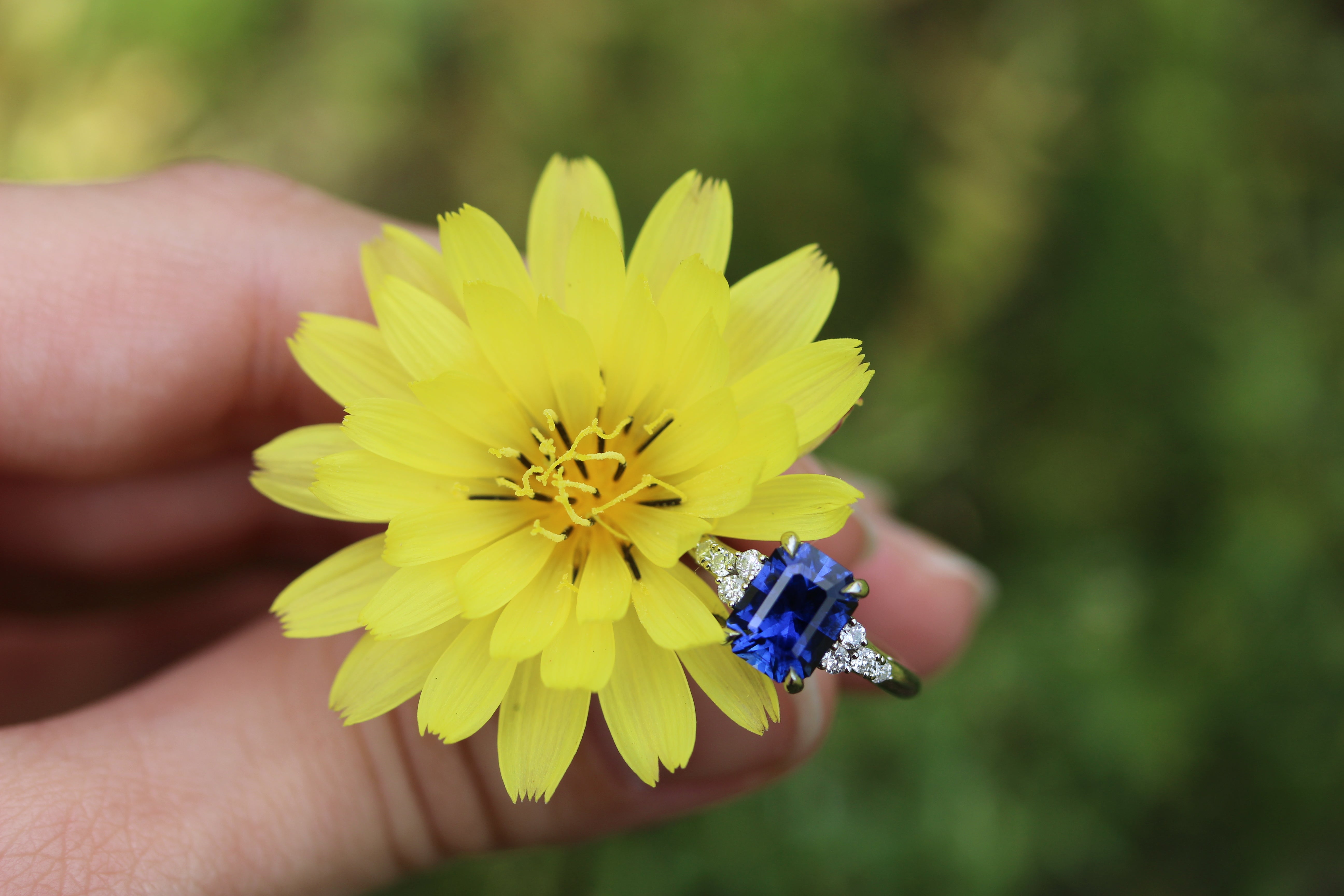 blue sapphire and diamond engagement ring with yellow flower