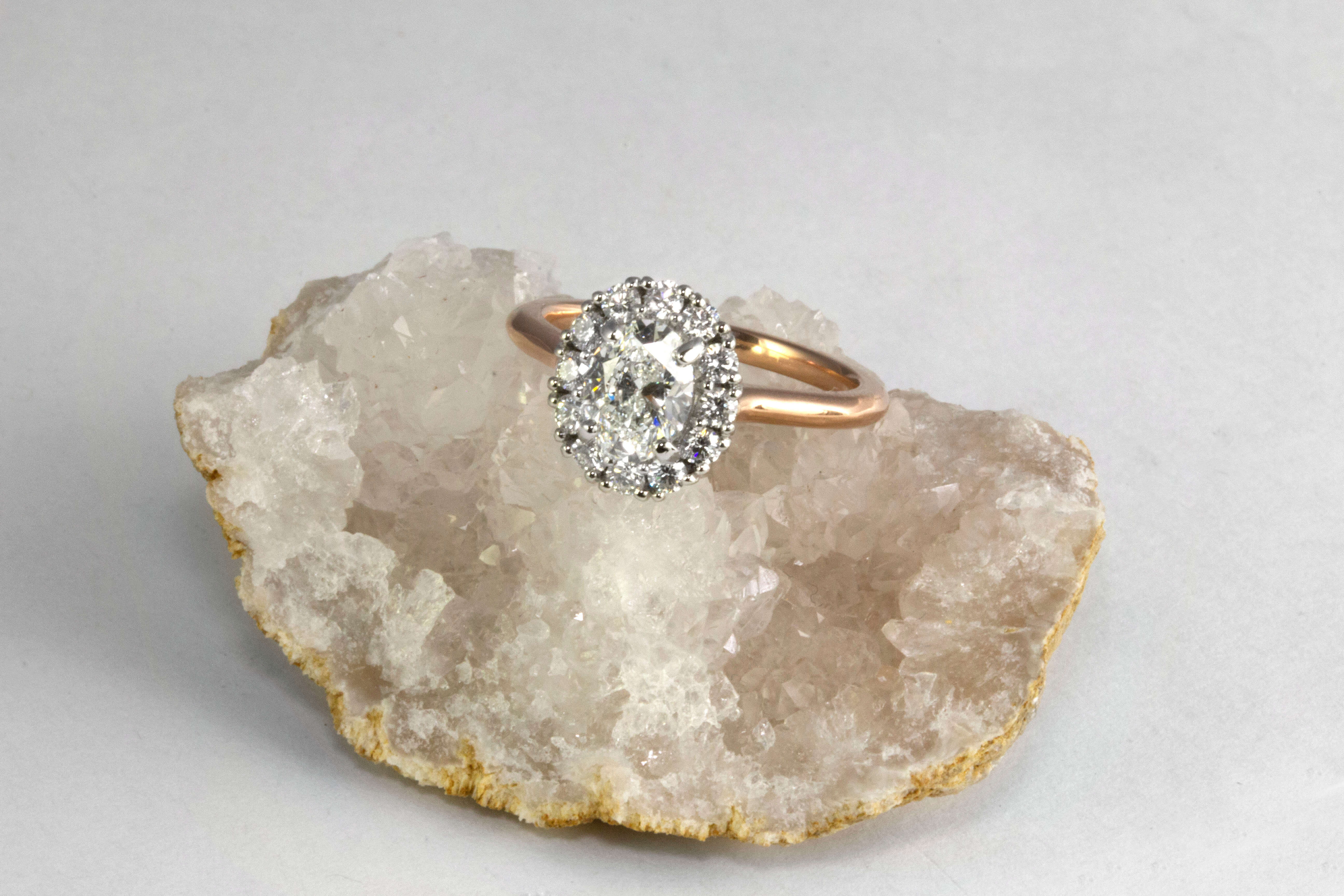oval halo platinum and rose gold engagement ring on crystal geode