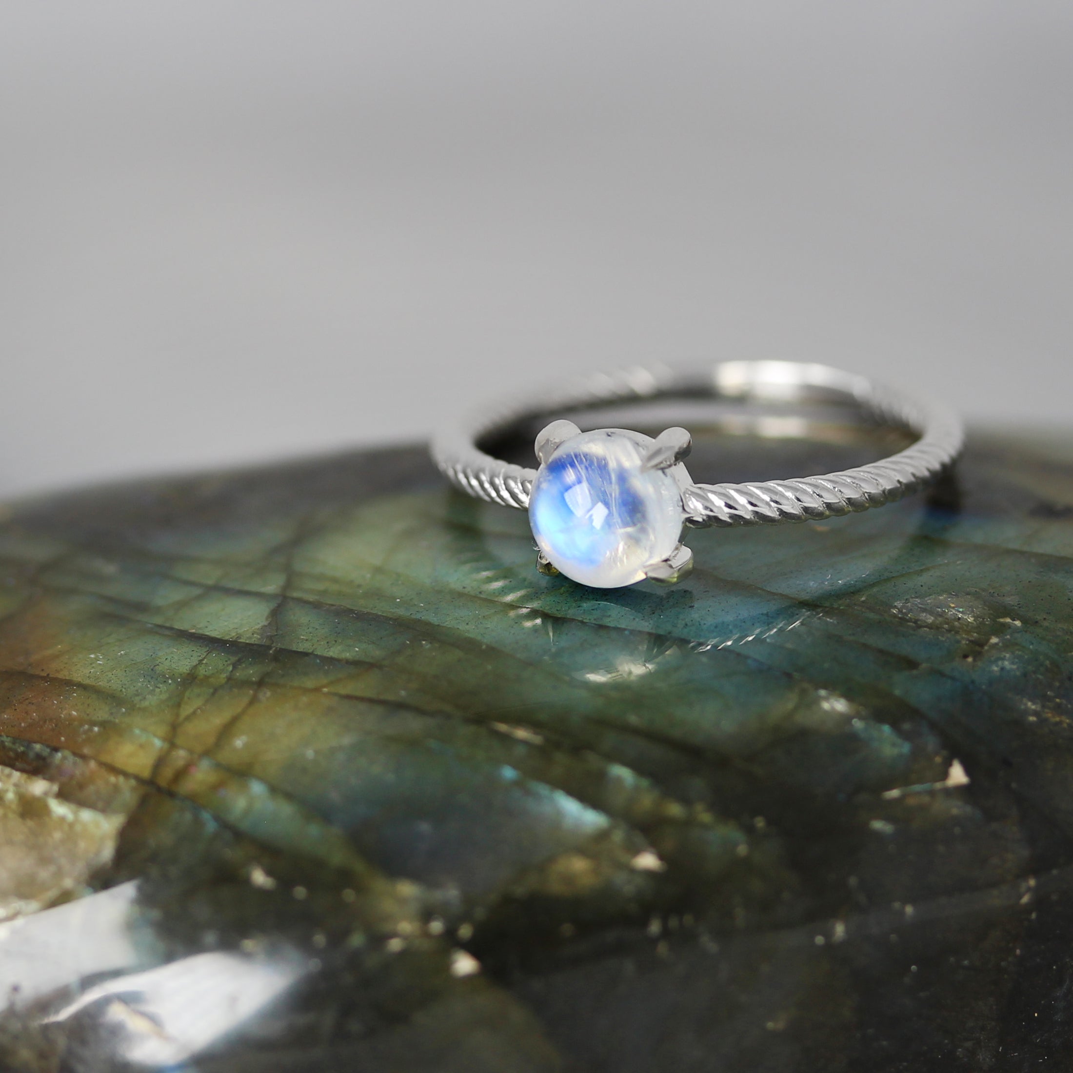 moonstone in silver rope ring on labradorite