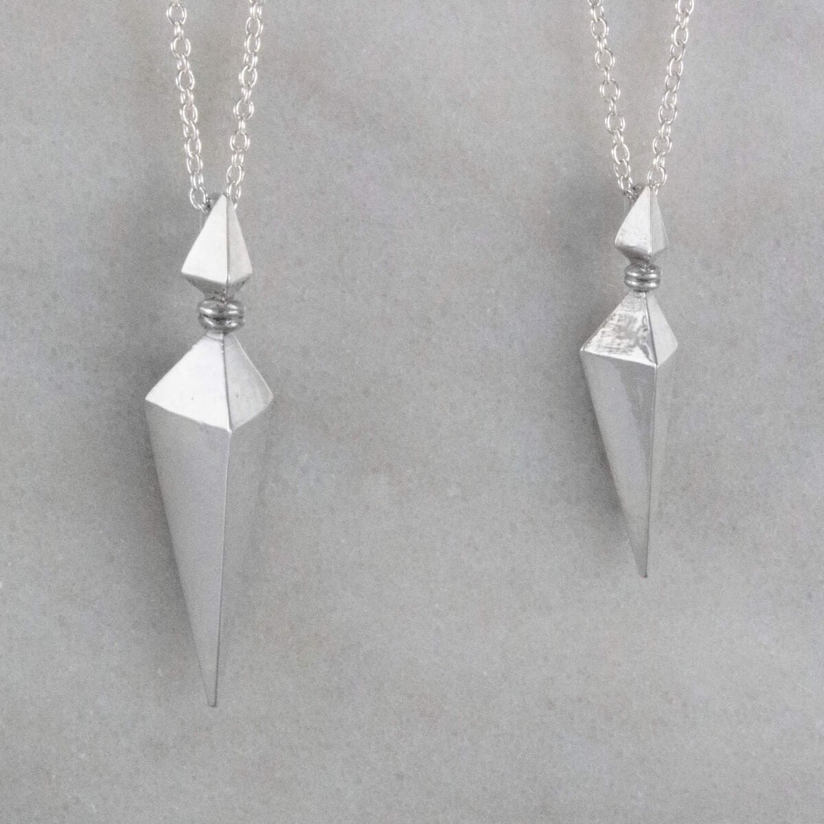 Large and Small Silver Pyramid Spike Pendants on Silver Chains Angled View
