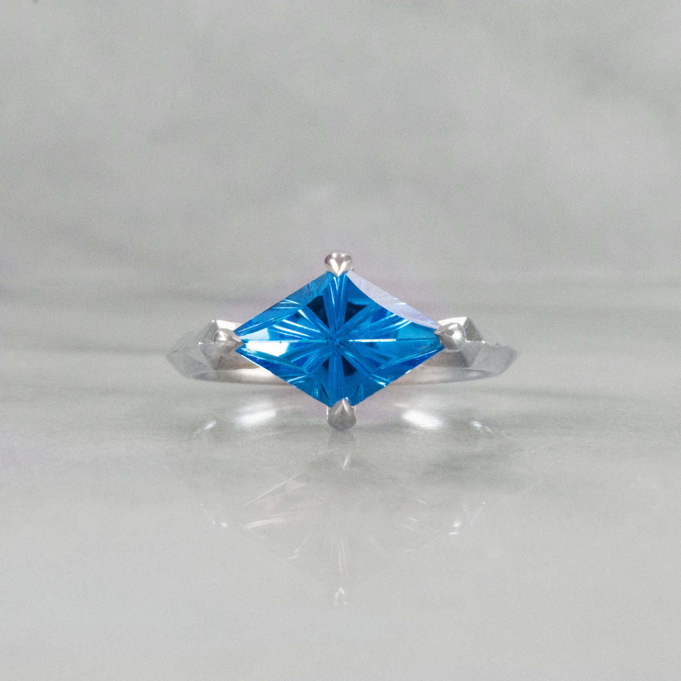Kite Shaped Blue Topaz Pyramid Ring laying down straight on view