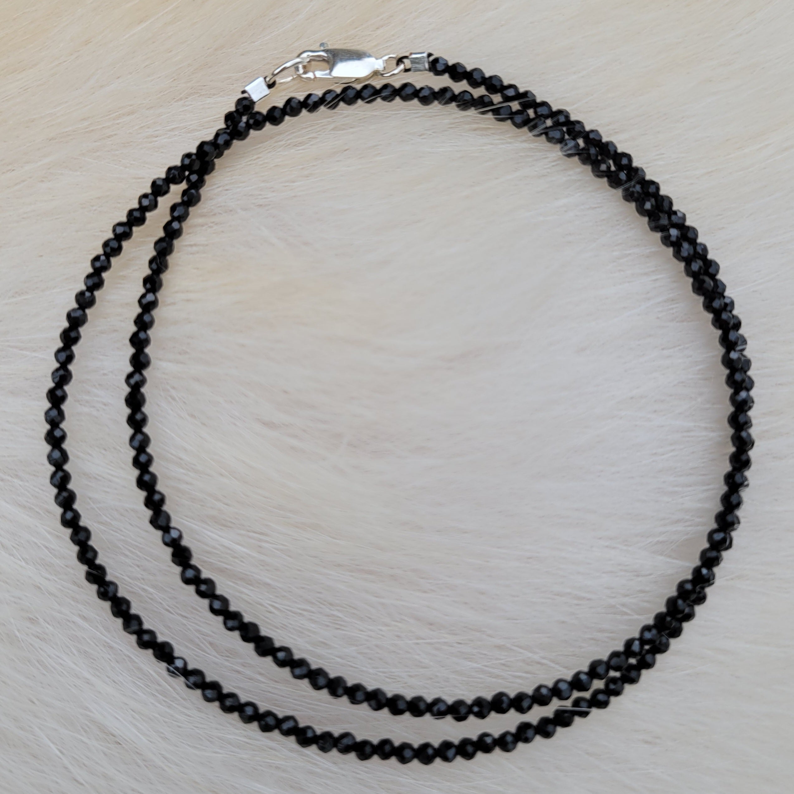 faceted black spinet beaded necklace on fur