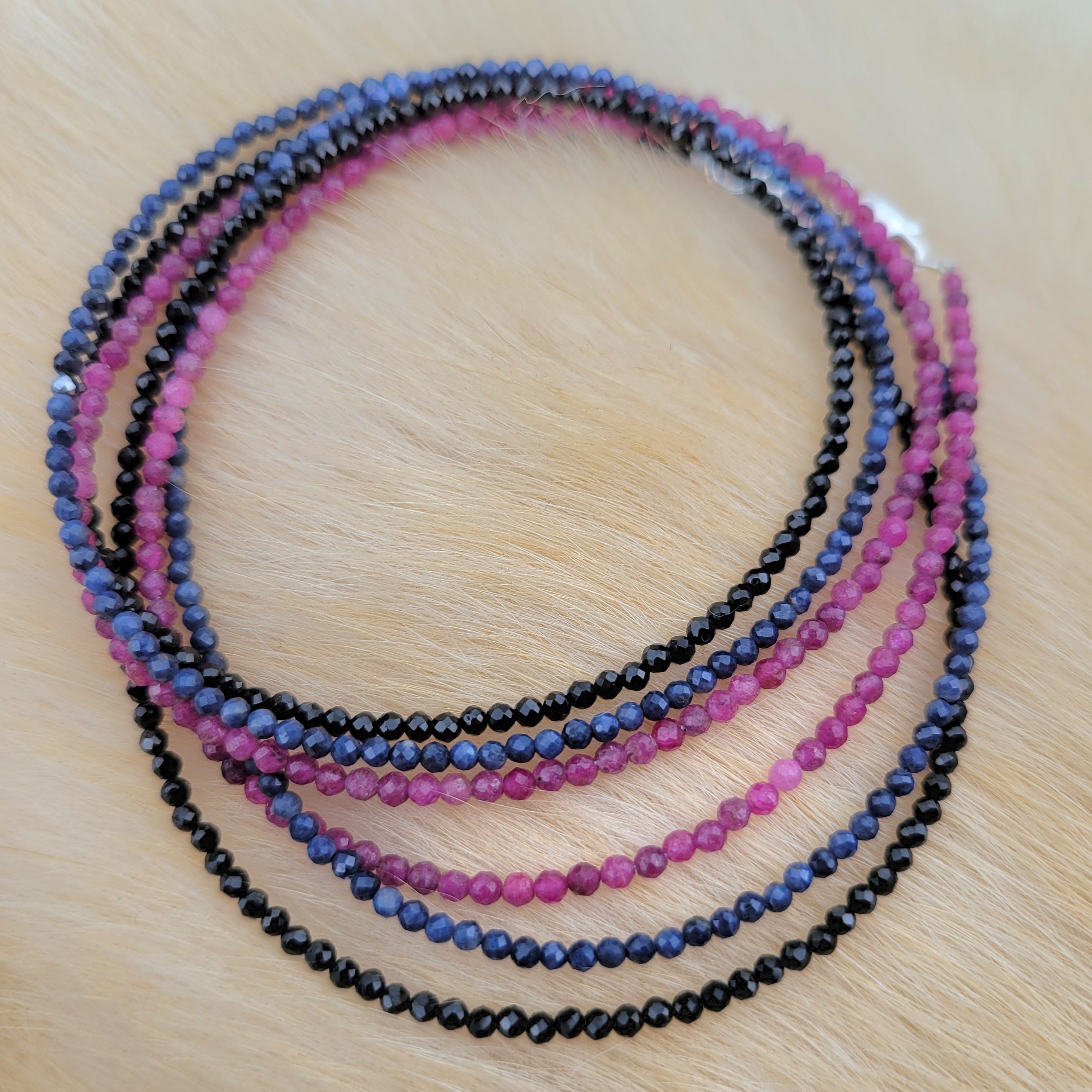 faceted gemstone beaded necklaces curled on fur