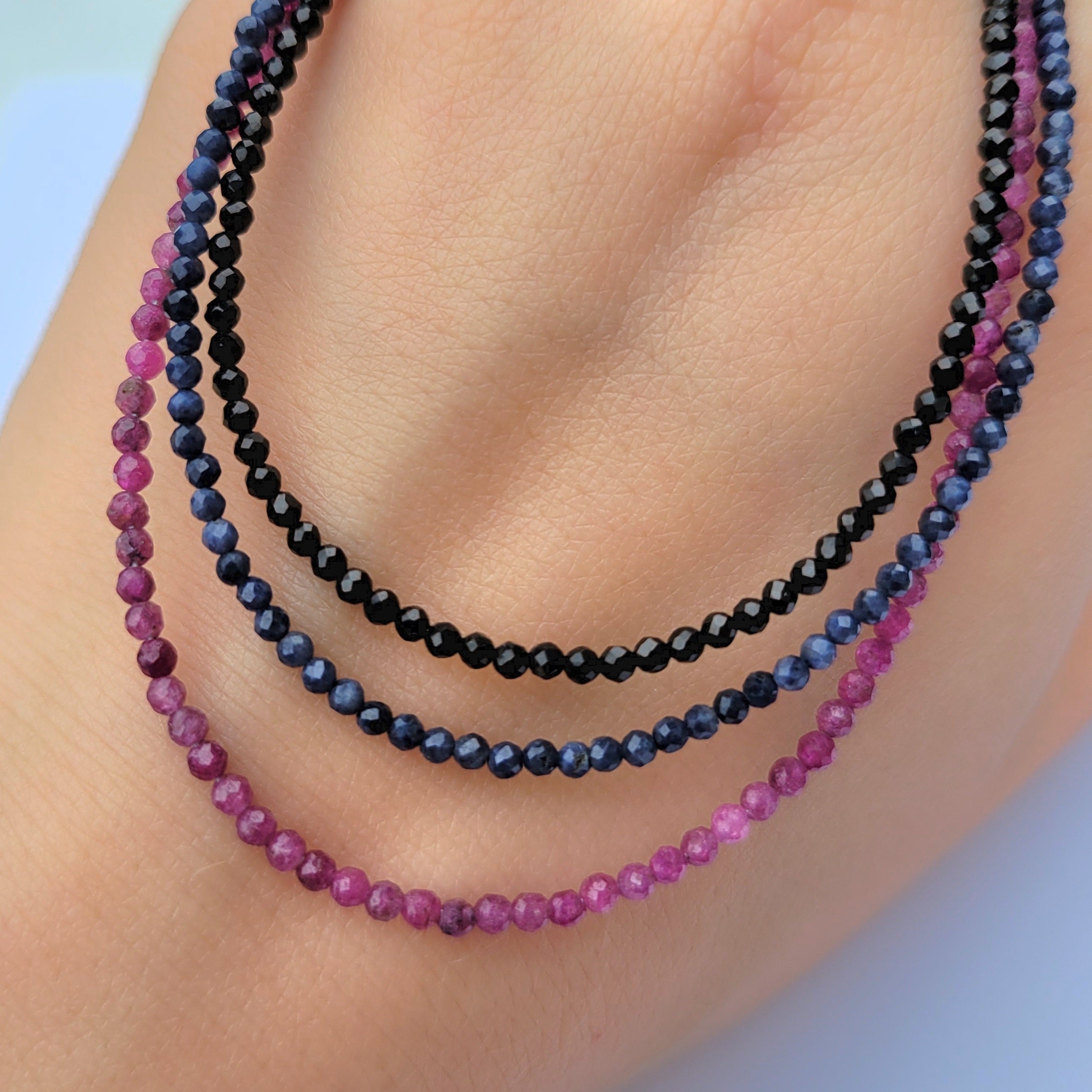 faceted gemstone beaded necklaces on hand