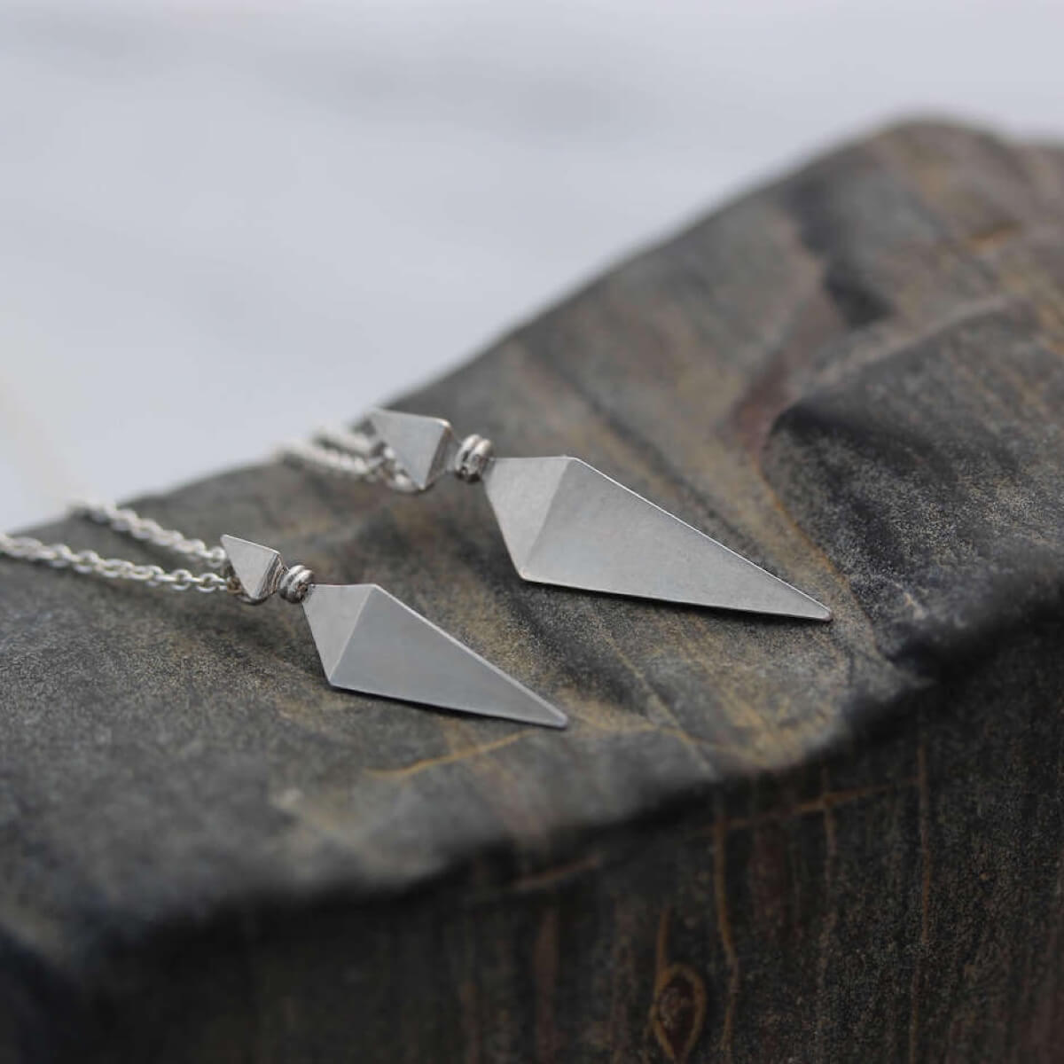Large and Small Silver Pyramid Spike Pendants on Silver Chains On Petrified Wood