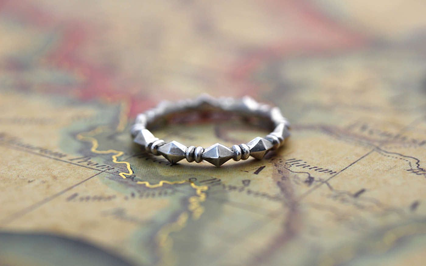 Stackable Pyramid Eternity Band on vintage map