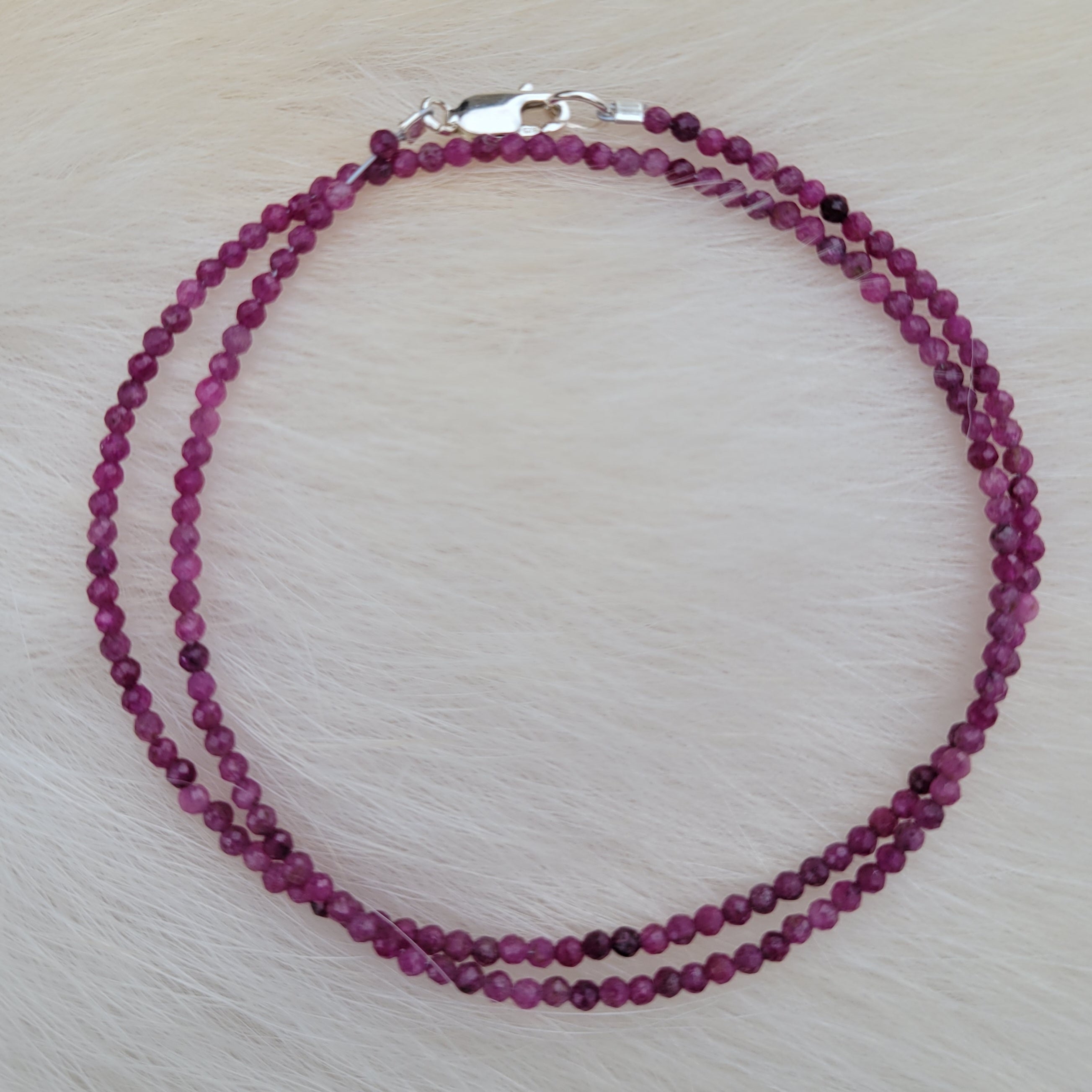 faceted ruby beaded necklace on fur