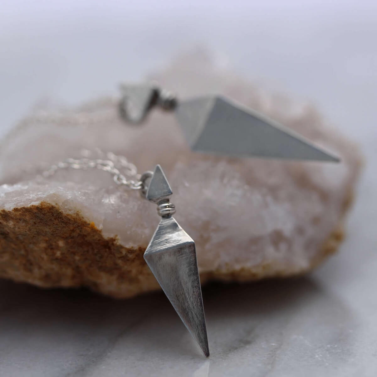 Large and Small Silver Pyramid Spike Pendants on Silver Chains On Crystal Geode